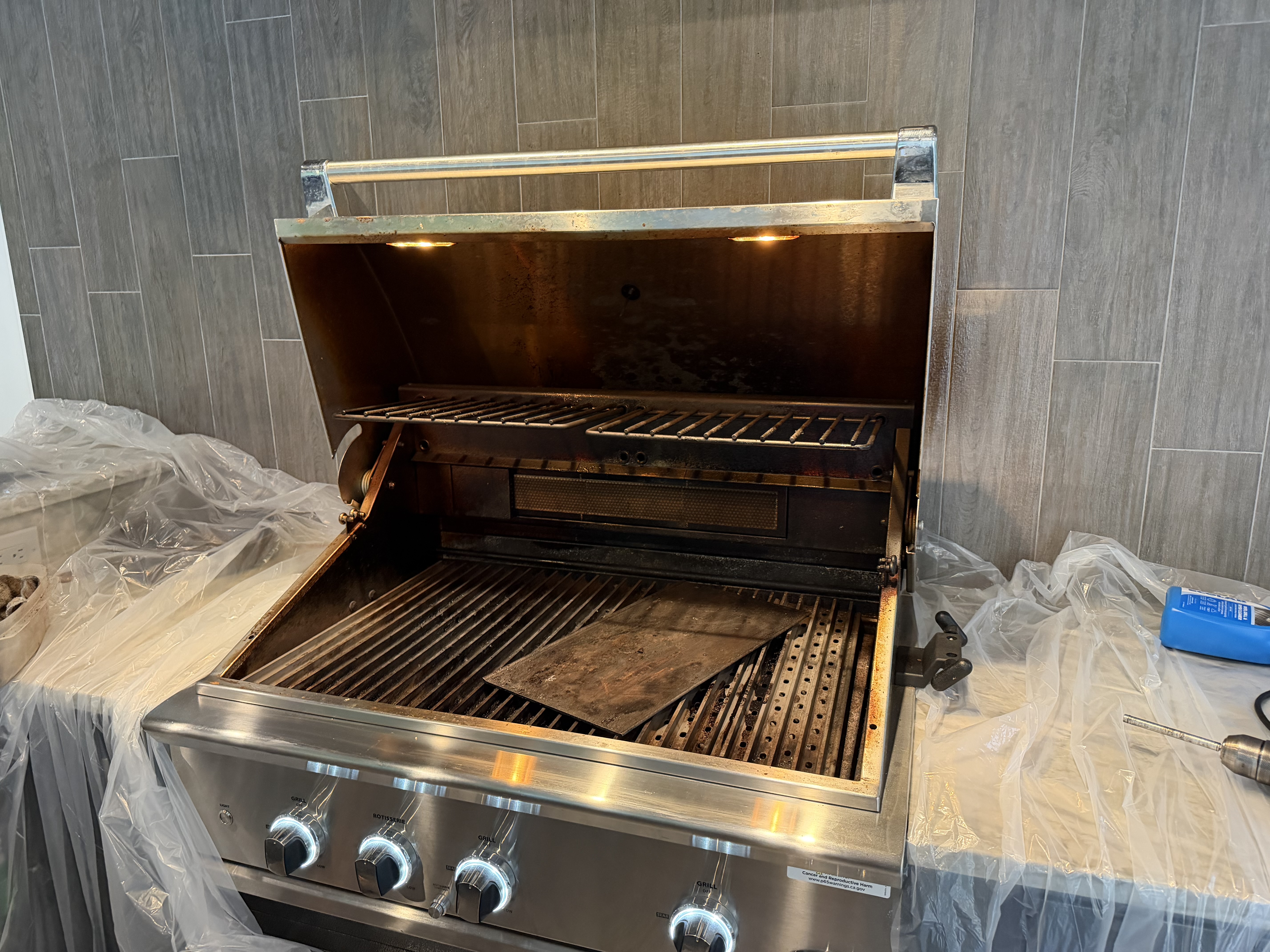 Before: a DCS 4-burner built-in with grease buildup on the hood interior and soot on the back wall