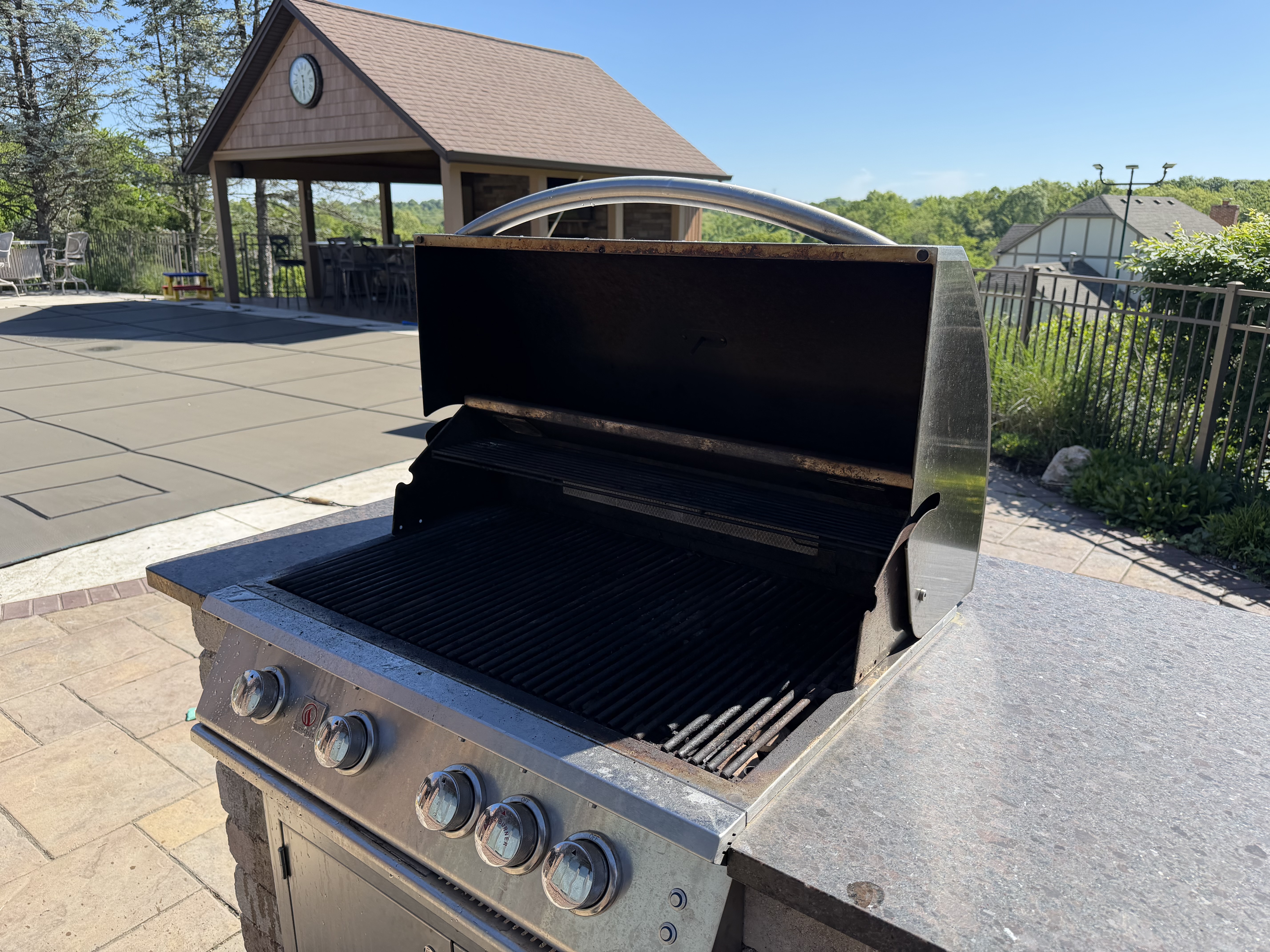 Before: a 5-burner built-in grill with carbonized buildup on the grates and grease across the cookbox